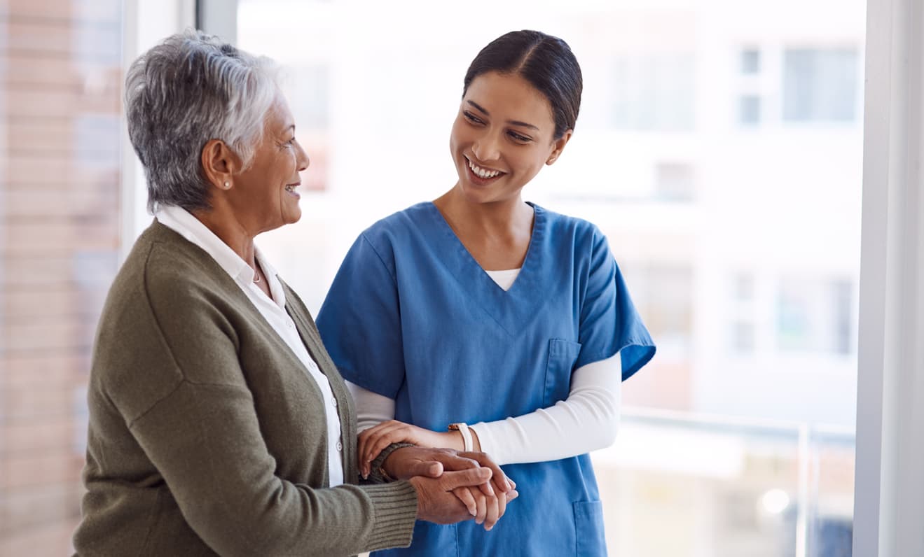 Real photo of a care manager on a call with an AI copilot panel on screen surfacing patient priorities, capable and warm.