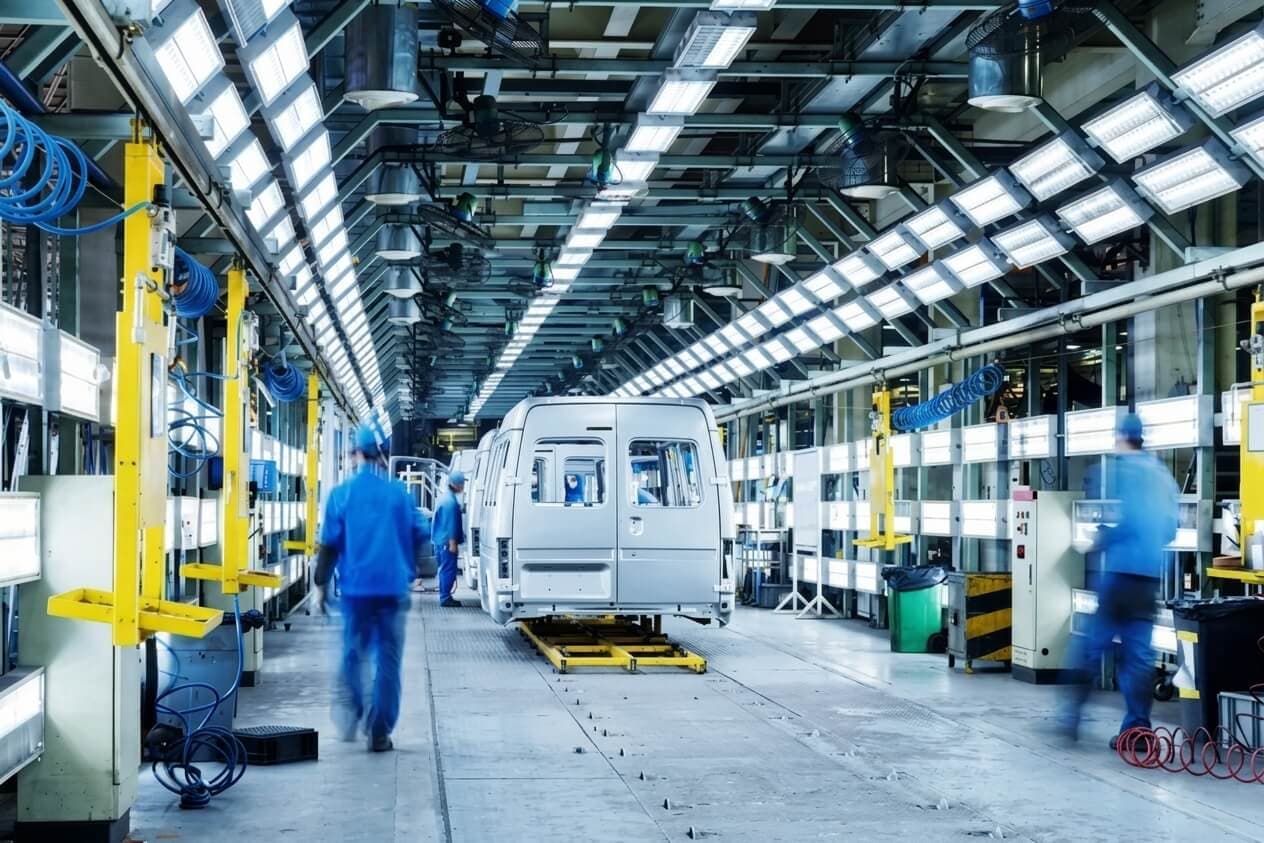 Real photo of an enterprise knowledge team reviewing connected data sources on a large dashboard, focused and organized.